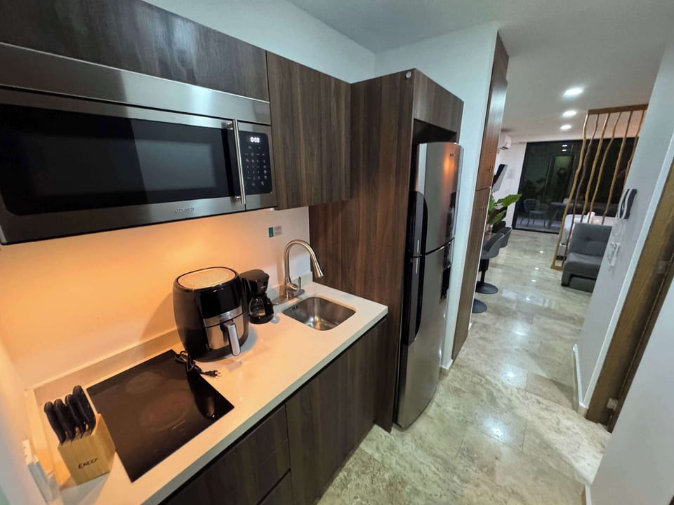 Modern kitchenette with microwave and coffee maker, everything you need for easy mornings