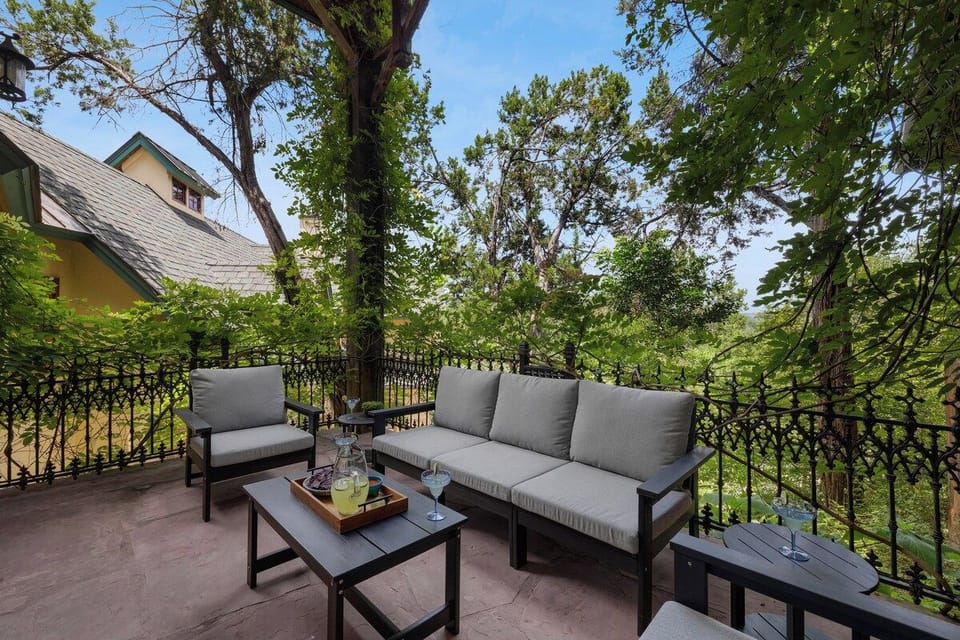 Covered deck lounge overlooking the green Hill Country canopy