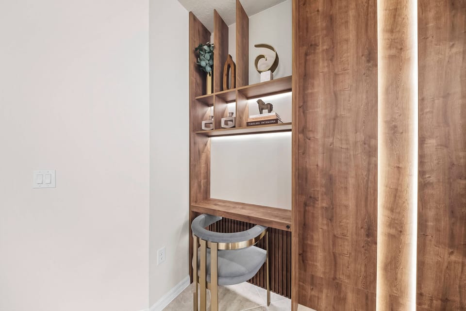 Discover a stylish workspace featuring warm wood tones and modern accents. The sleek circular chair and carefully arranged decor, including sculptures, foster an inspiring atmosphere that enhances your productivity.