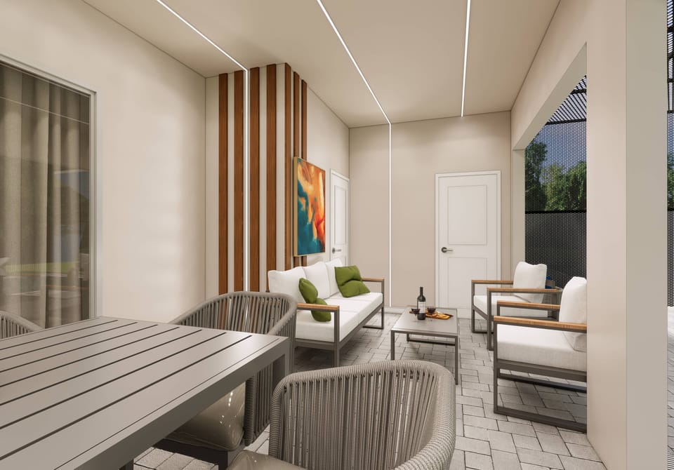 Relax in our cozy sitting area with plush white sofas and bright green cushions. Enjoy the stylish wooden accent wall and modern artwork while large windows bring in natural light and beautiful outdoor views.