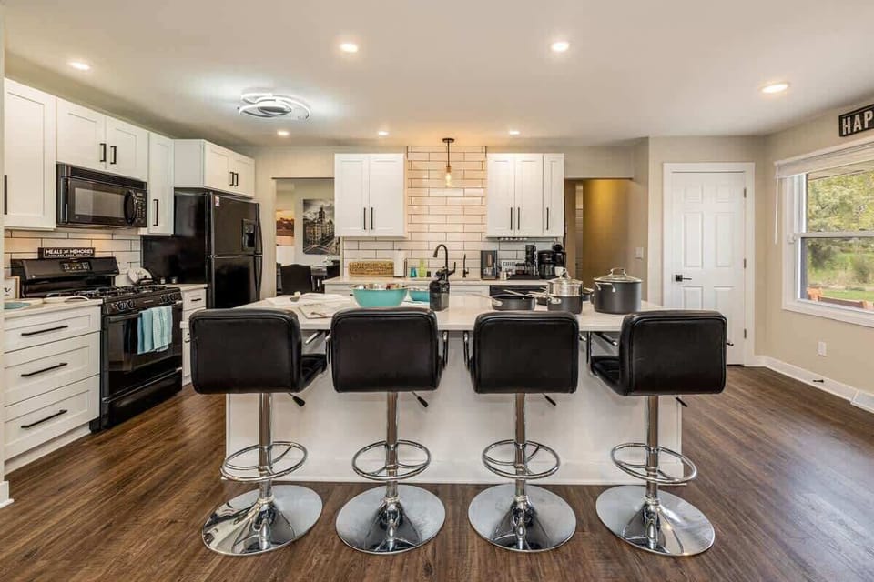 Bring your favorite recipes (or just your takeout) to this kitchen built for a crowd—massive island, fully stocked cookware, and a coffee corner that works harder than your Monday morning.