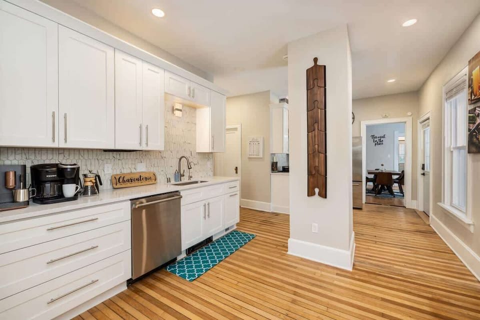 Cook with ease in this bright, modern kitchen featuring sleek white cabinetry, updated appliances, and plenty of space to prepare meals while staying connected to the rest of the home.