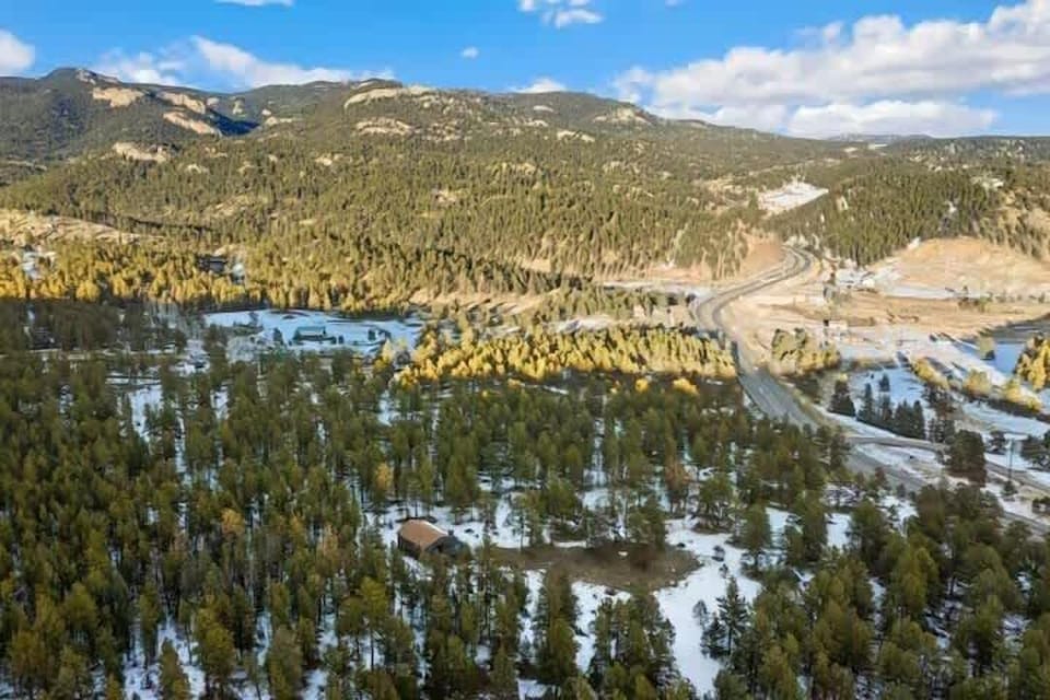 Aerial view of the mountain setting and surrounding forest