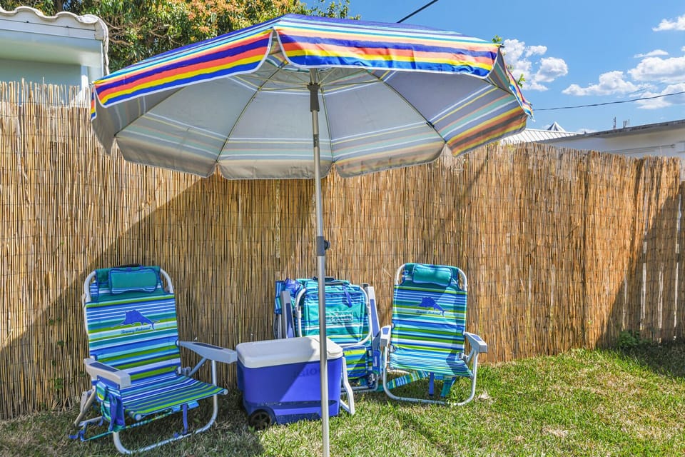 Beach chairs, umbrella and cooler on wheels are provided for you