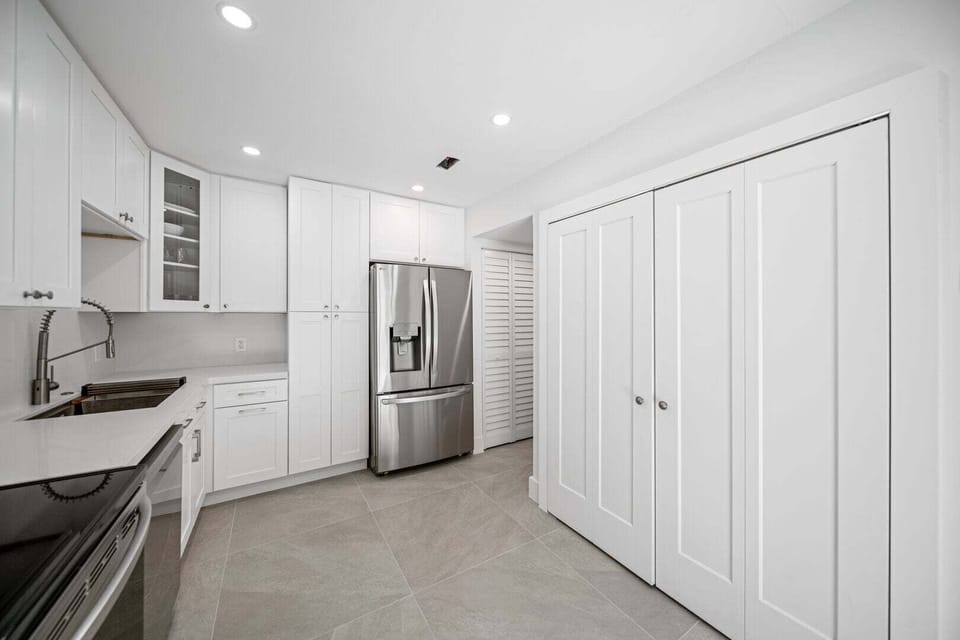Fully stocked kitchen with cookware and utensils