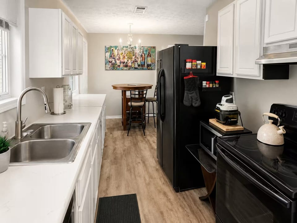 Fully equipped kitchen with full size appliances, ample counters, & dining nook.