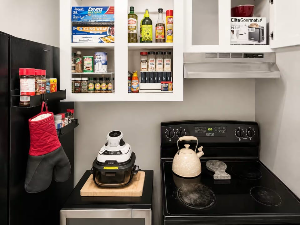 
Well stocked kitchen with stove, air fryer, spices and cooking essentials.