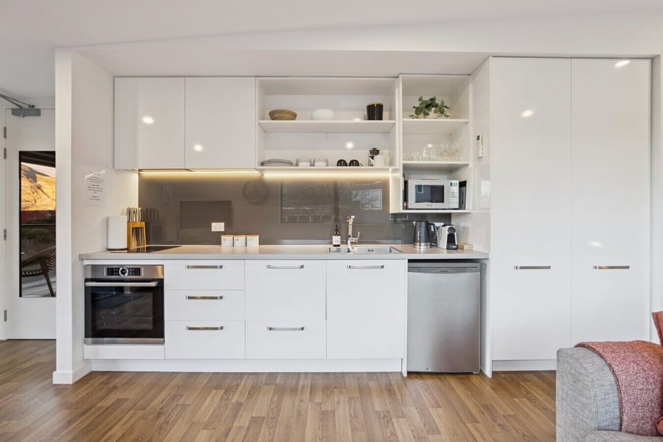 Fully equipped kitchen with oven and stainless steel appliances
