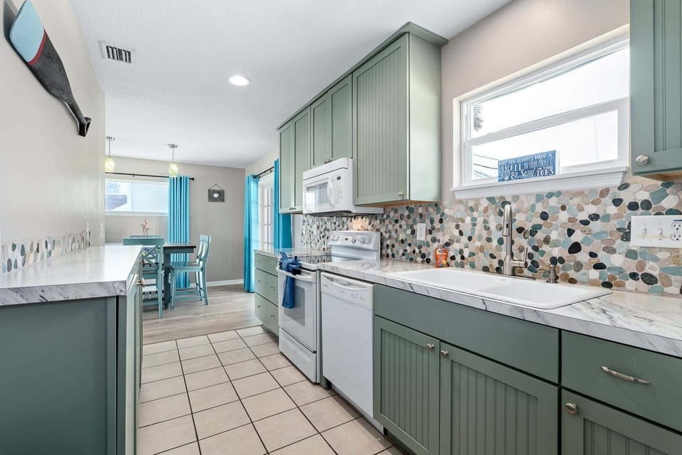 The kitchen features a bright window that fills the space with natural light throughout the day.