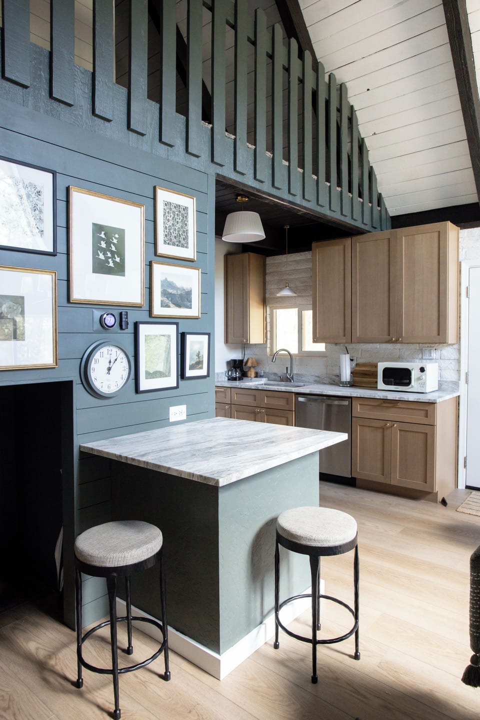 Stylish kitchen with soaring ceilings, breakfast bar, and modern finishes