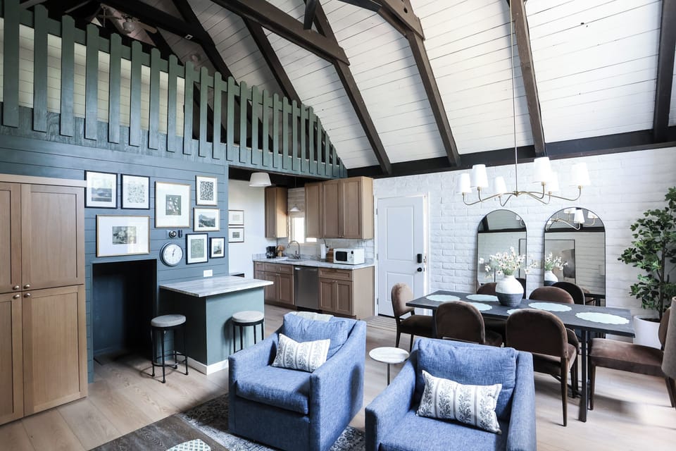 Bright vaulted great room with kitchenette, dining space, and designer touches