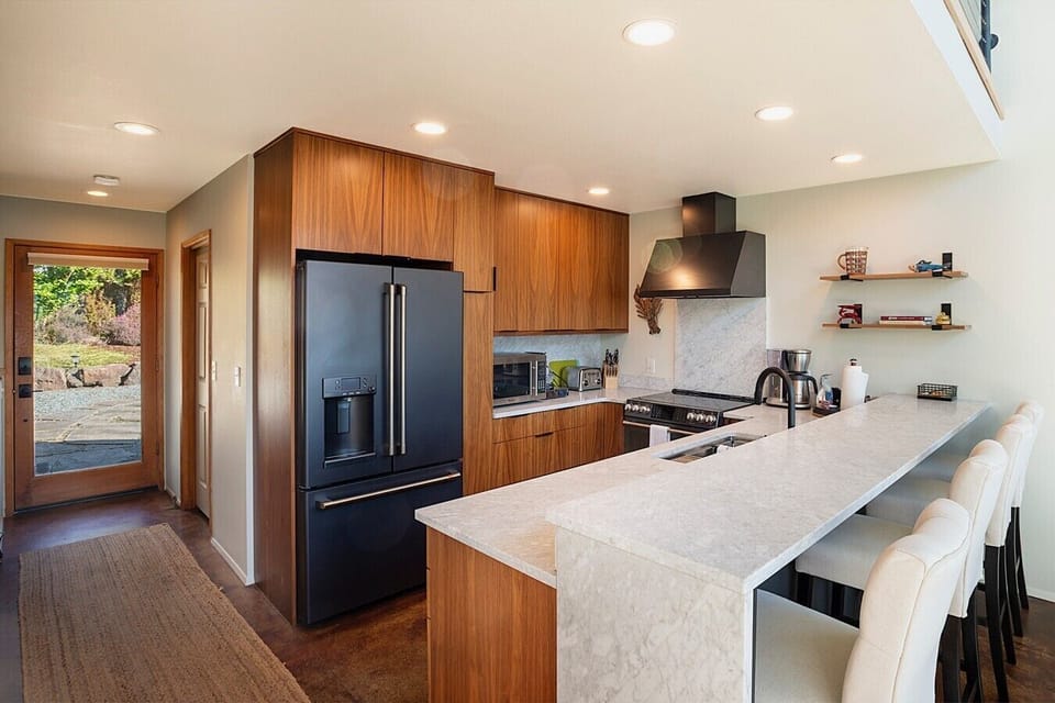 Modern chef’s kitchen featuring premium appliances, generous counter space, and island seating.