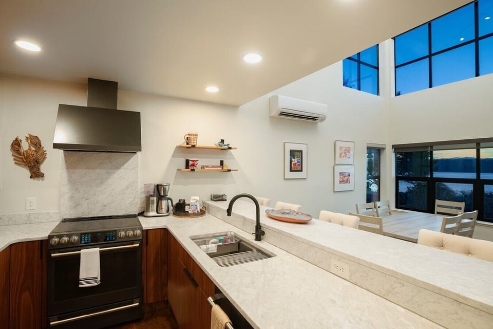 Contemporary kitchen with stainless steel appliances and island seating