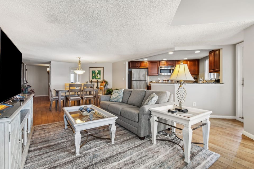 Spacious Living Room Featuring Panoramic Oceanfront Views, Seating Area with Plush Swivel Chairs, and a Flat Screen Smart TV (Sleeper Sofa)