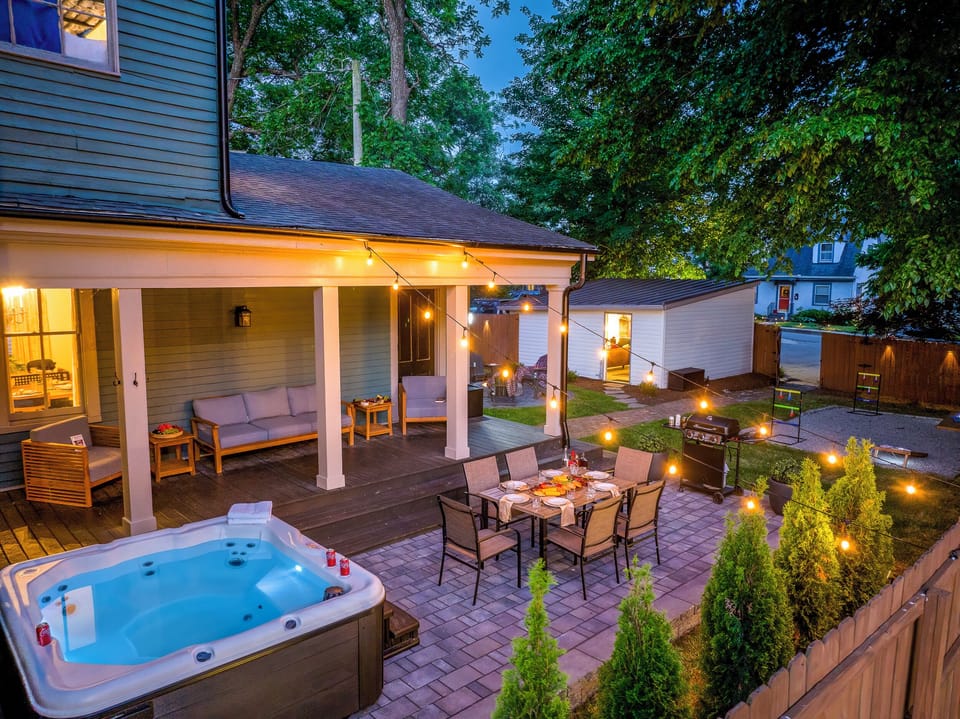 Every inch of the backyard is lit up for the perfect night, with the hot tub glowing, string lights twinkling, and the fire pit ready to enjoy.