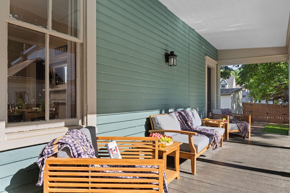 Relax on the covered back porch in teak loungers, the perfect spot for a morning coffee or a leisurely evening pour.