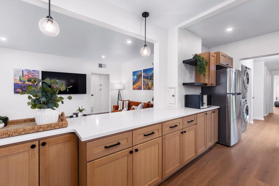 Spacious kitchen with microwave and refrigerator.