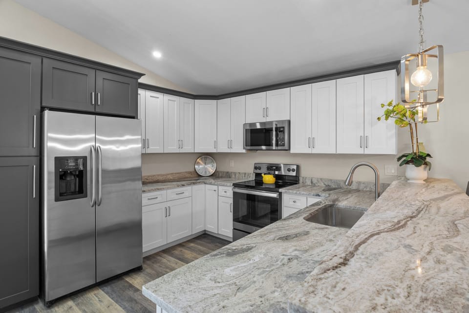 Fully equipped modern kitchen with premium solid-surface countertops.
