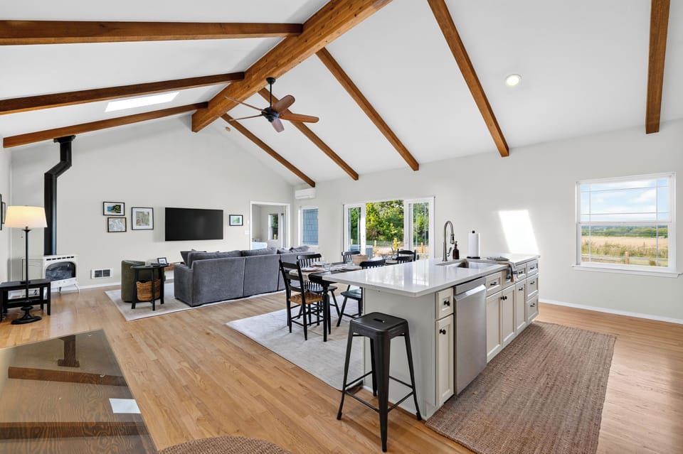 Overview of the complete open-plan layout, from the living room to the central kitchen island.