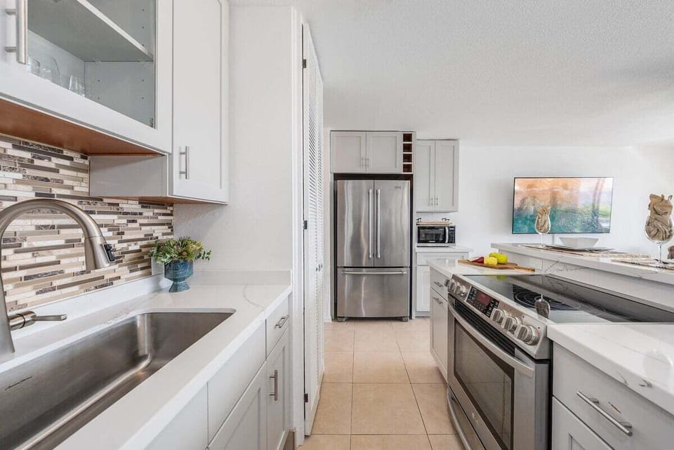 Modern updated kitchen with granite counters and stainless-steel appliances