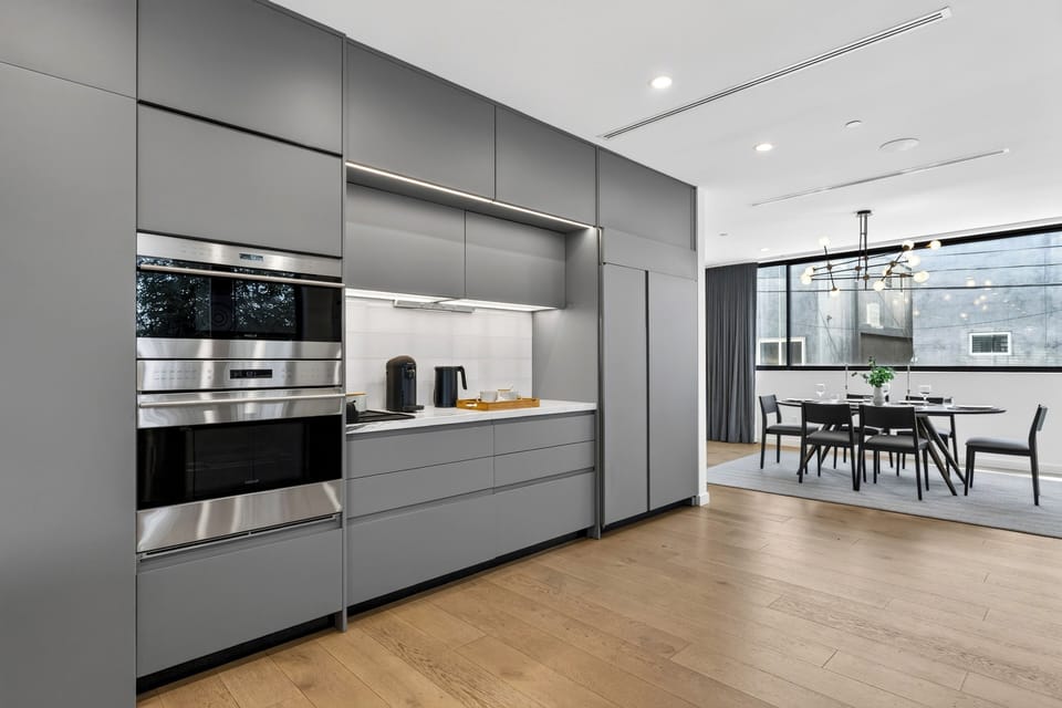 Open kitchen with wood floors flowing toward the dining area.