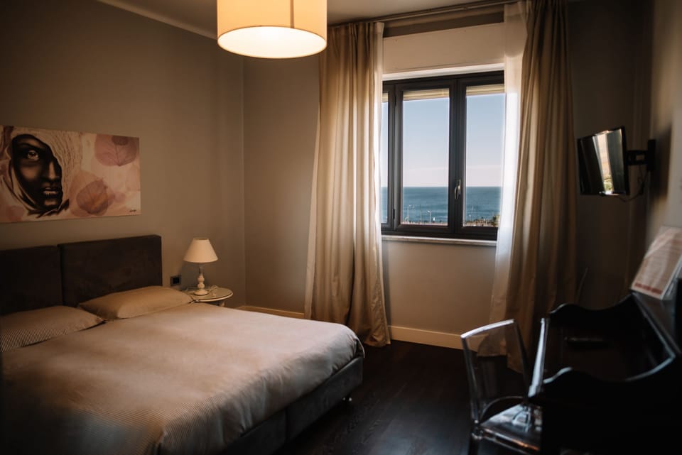 Panoramic Quadruple Room, Ocean View | Frette Italian sheets, premium bedding, down comforters