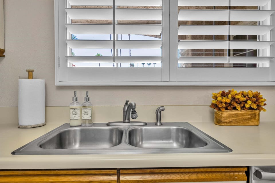 Kitchen sink with plantation shutters and bright natural light