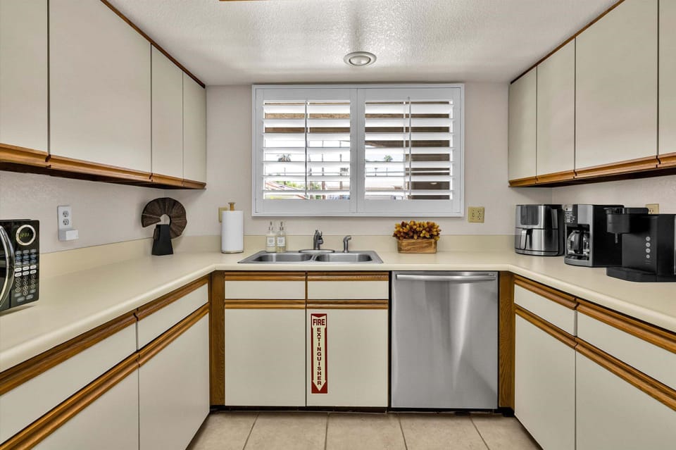 Bright kitchen workspace with dishwasher and coffee station