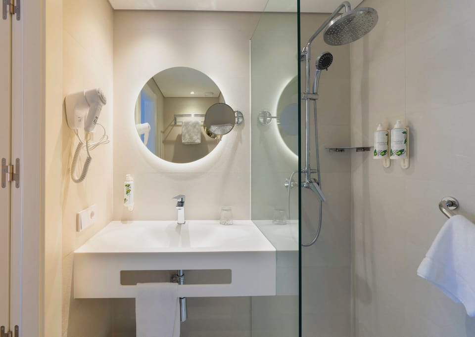 Shower, hair dryer, slippers, towels
