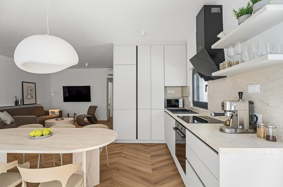 The kitchen comes equipped with an espresso coffee maker, microwave oven, refrigerator, kettle, and more essential appliances