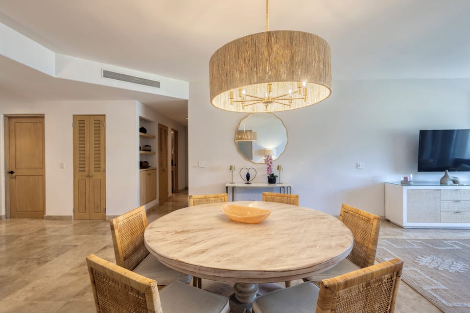 Gather around the beautifully crafted round table under soft ambient lighting, where every meal becomes a cherished memory in your elegant vacation retreat.