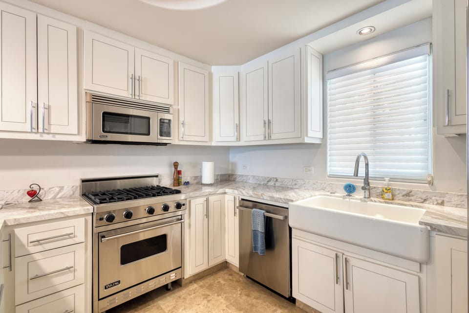 Your gourmet kitchen features elegant marble countertops, professional-grade Viking appliances, and a charming farmhouse sink—perfect for creating memorable meals during your stay.