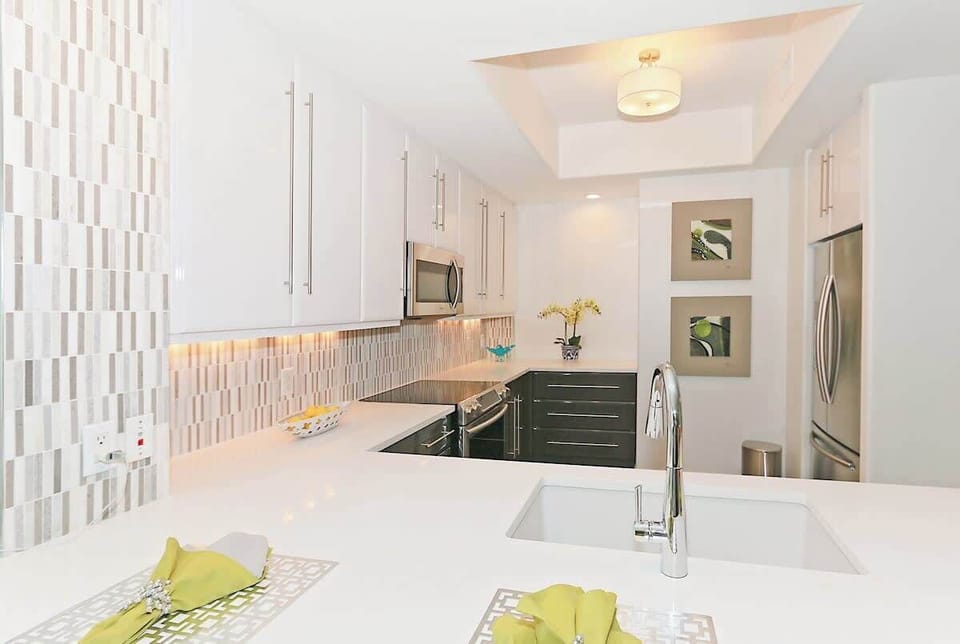 White and Gray Lacquered cabinets make this kitchen a dream