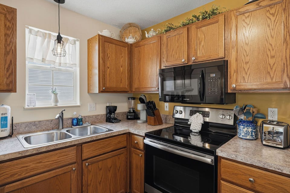 Your fully equipped kitchen features warm oak cabinetry, modern appliances, and everything you need to prepare delicious meals during your stay.