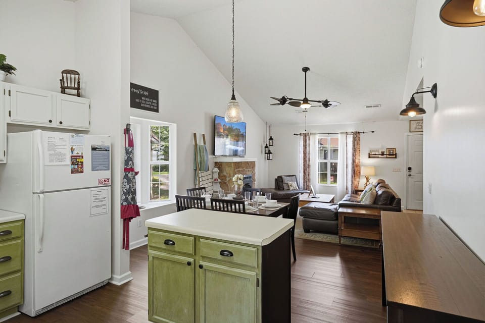 Relax in your open-concept living space with vaulted ceilings, cozy fireplace, and a fully equipped kitchen—perfect for gathering, cooking, and unwinding after a day of adventure.