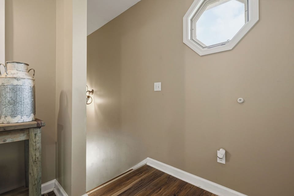 Natural light streams through the skylight above, illuminating this cozy nook with warm hardwood floors and a touch of rustic charm.