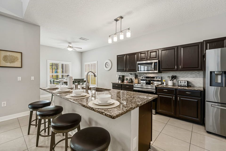 Gourmet Kitchen – Gather around the oversized breakfast bar with seating for four, while enjoying a fully equipped kitchen designed for effortless meals and memorable moments.