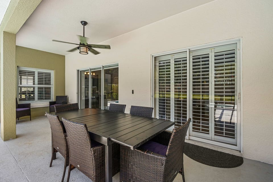 Enjoy shaded outdoor dining and comfortable seating overlooking the pool.