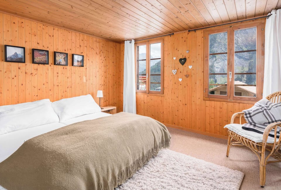 Cozy master bedroom with a comfortable double bed and warm chalet-style interior.

