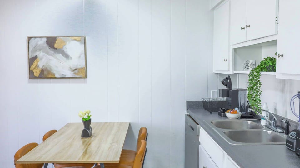 Bright kitchenette with cozy dining table and convenient coffee station