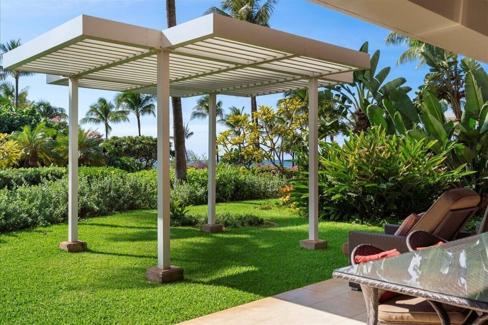 Step onto your private terrace where tropical gardens meet ocean views, perfect for morning coffee or sunset relaxation.
