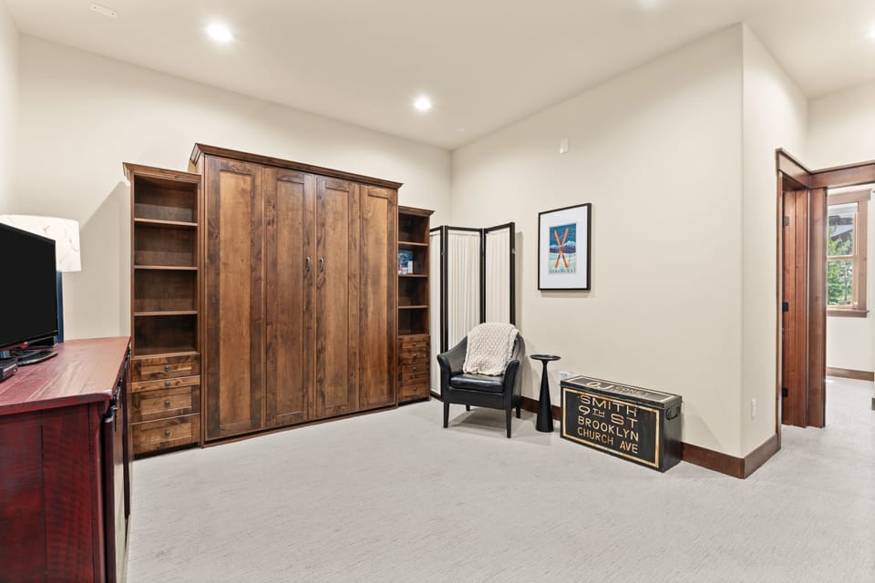Settle into your cozy reading chair in this spacious bedroom, complete with vintage-inspired accents and a large wardrobe to keep your belongings organized throughout your stay.