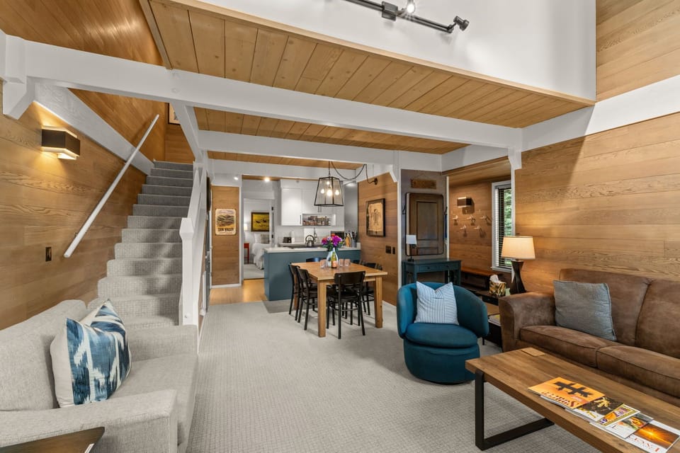 Cozy open-concept living space with warm wood finishes and lodge charm
