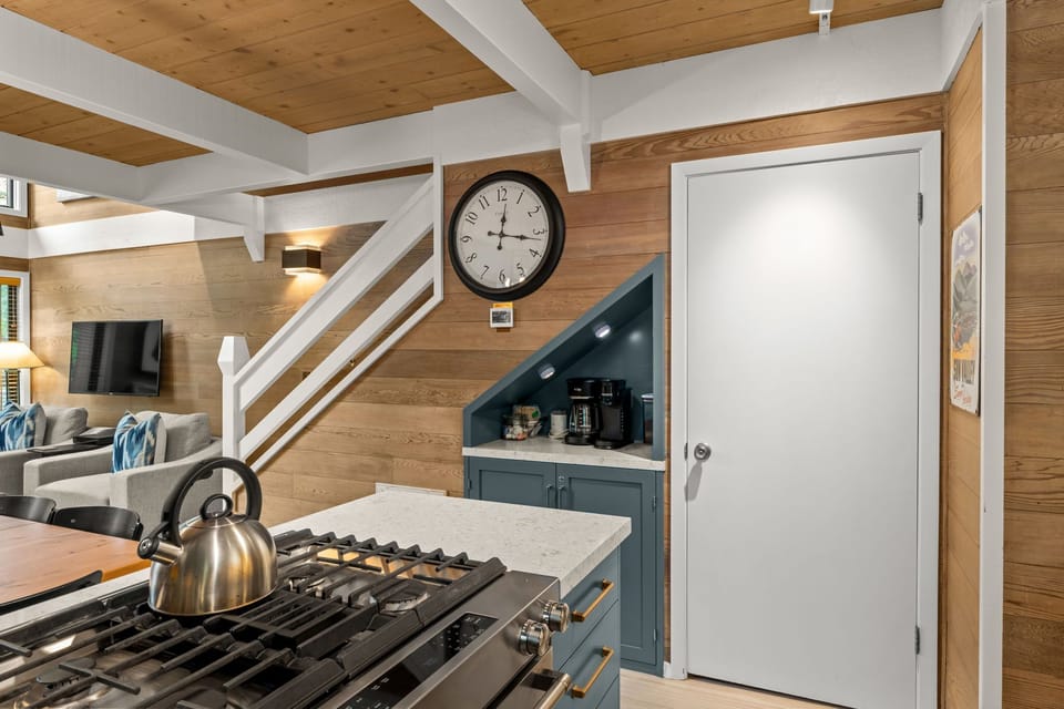Warm wood accents, gas cooktop, and cozy built-in coffee nook