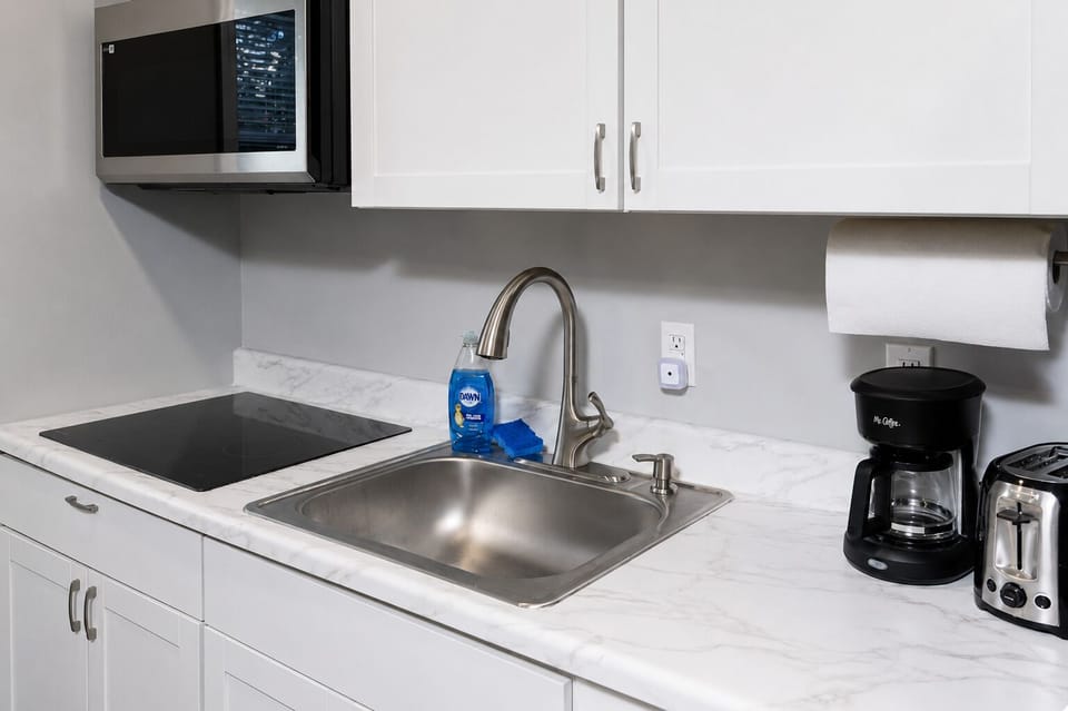 Fully equipped kitchen with coffee and a cozy island for two.