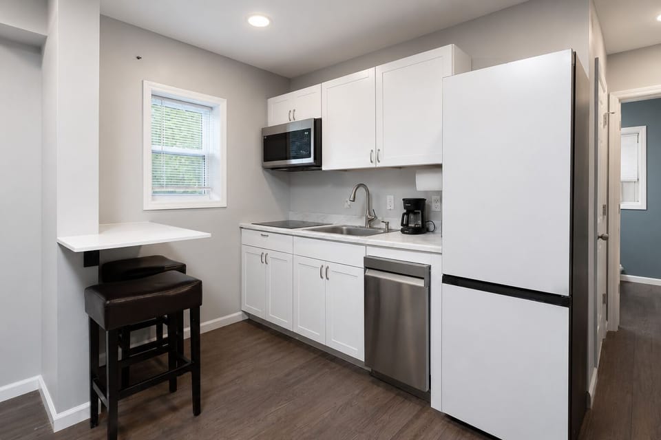 Fully equipped kitchen with coffee and a cozy island for two.