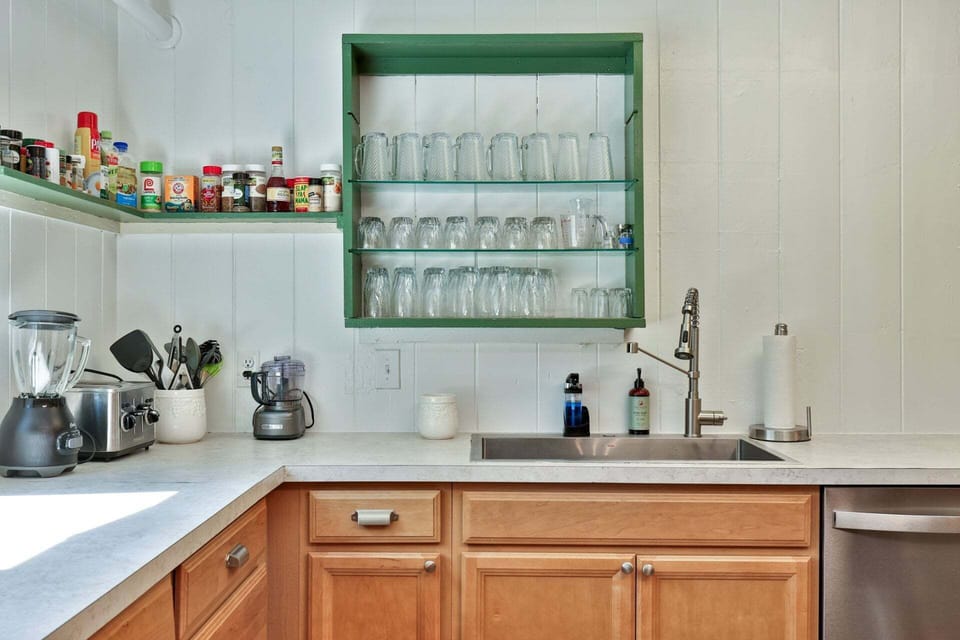 A separate prep sink and open shelving make it easier to serve drinks and meals for a crowd.