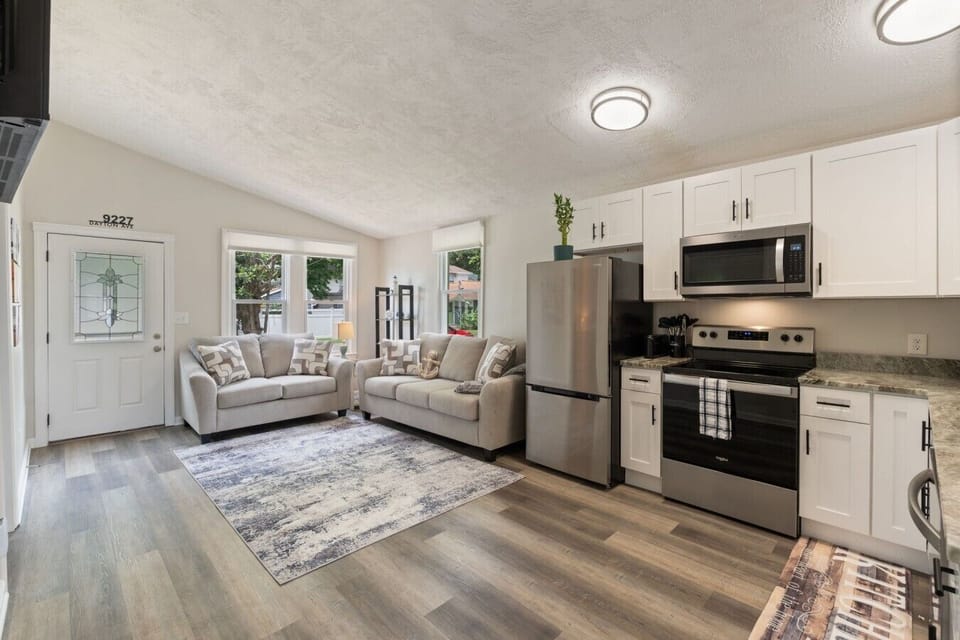 Spacious living area with comfortable seating, Smart TV, and a fully stocked kitchen just steps away.