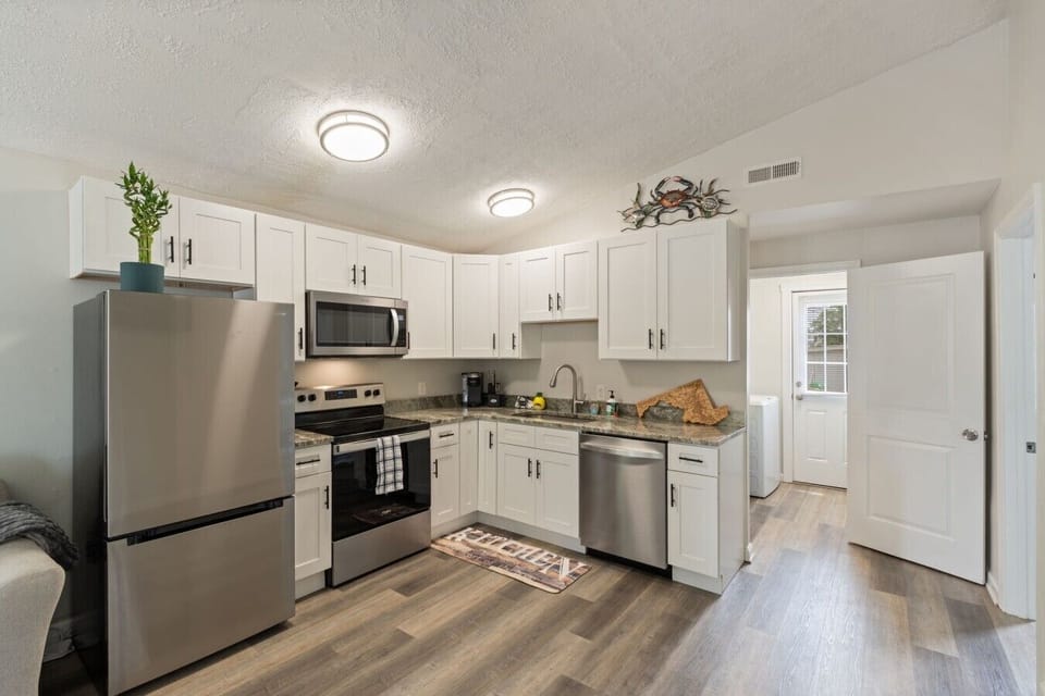 Bright kitchen with generous counter space and convenient access to the laundry room.