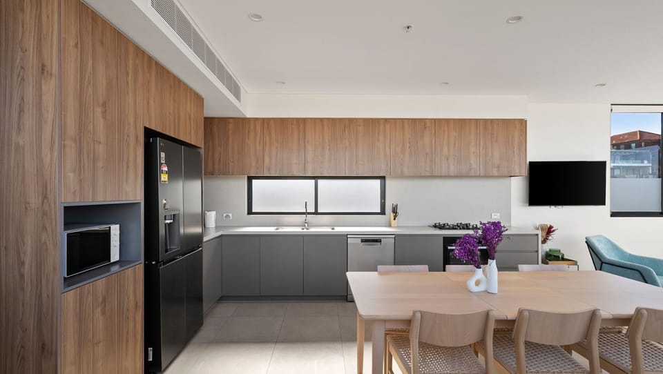 The designer kitchen combines premium appliances with elegant finishes.